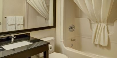 Guest bathroom with tub at Comfort Inn Pickering.