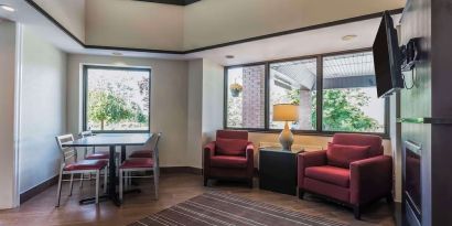 Lobby lounge with TV screen and fireplace at Comfort Inn Cobourg.