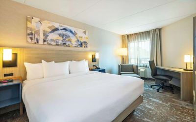 Bright and spacious day use room with work desk and sofa at Comfort Inn Kingston HWY 401.
