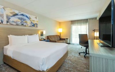 Standard day use room with TV, work desk, sofa and private bathroom at Comfort Inn Kingston HWY 401.