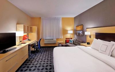 Day use room with TV, work desk and sofa at TownePlace Suites By Marriott London.