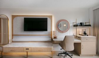 Day use room's workspace with TV screen and workdesk with ergonomic chair at Sonesta Miami Airport.