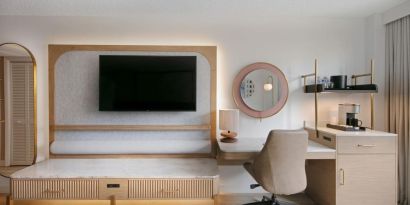 Day use room's workspace with TV screen and workdesk with ergonomic chair at Sonesta Miami Airport.