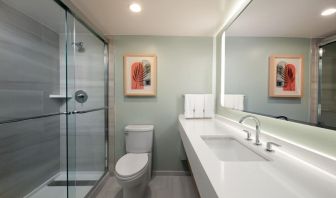 Private guest bathroom with shower and free toiletries at Sonesta Miami Airport.