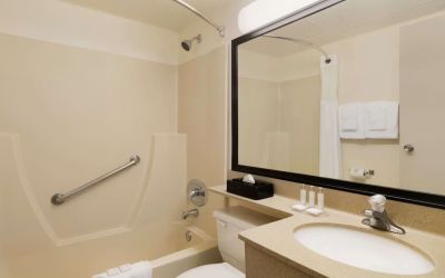 Guest bathroom with tub and free toiletries at Travelodge Edmonton South.