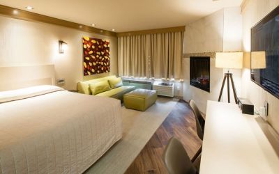 Day use room with TV, work desk, fireplace and private bathroom at Le Chabrol Hotel Et Suites.