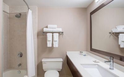 Guest bathroom with shower and tub at Delta St. John's Hotel & Conference Center.