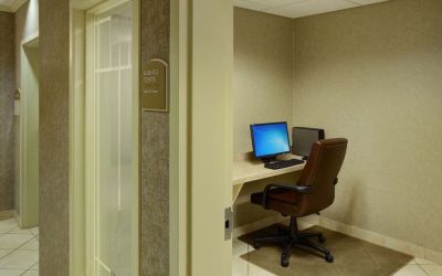Business center with computer, printer and ergonomic chair at Holiday Inn Express & Suites Medicine Hat.