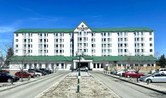 Hotel exterior and parking area at Divya Sutra Plaza & Conference Centre.