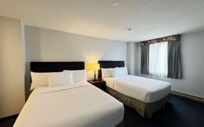 Bright and spacious day use twin room at Divya Sutra Plaza & Conference Centre.