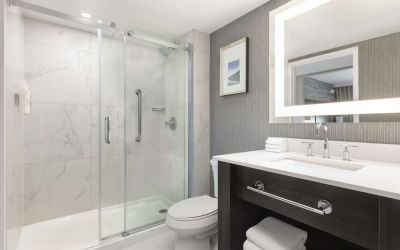 Guest bathroom with shower and free toiletries at Embassy Suites By Hilton Toronto Airport.