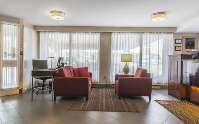 The hotel lobby has comfortable seating, and is brightly lit thanks to large windows.