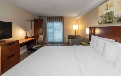 Day use room with TV, work desk and sofa at Comfort Inn Sault Ste. Marie.