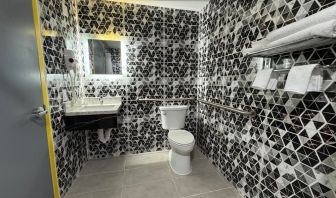 Bathroom with shower  at Days Inn Chinatown NYC.