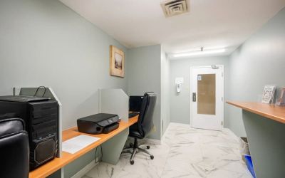 Business center with computers, printer and ergonomic chairs at Halifax Airport Hotel.
