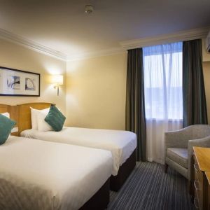 Day use twin room with work desk and sofa at Thistle London Heathrow Terminal 5.