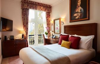 Day room with work desk and TV at The Royal Horseguards Hotel.