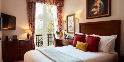 Day room with work desk and TV at The Royal Horseguards Hotel.