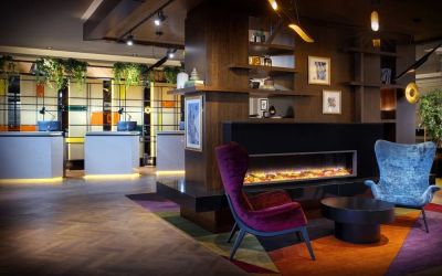 Lobby lounge with fireplace at Leonardo Royal Hotel London City.