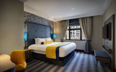Day use room with work desk and TV screen at Leonardo Royal Hotel London City.