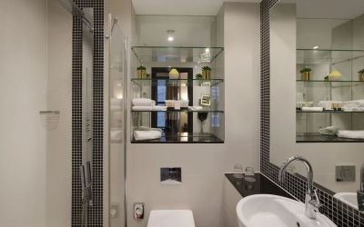 Guest bathroom with shower and free toiletries at Leonardo Royal St Paul's Hotel.