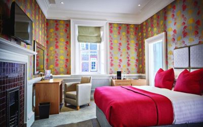 Day use room with work desk, TV screen and fireplace at Barnett Hill Hotel.