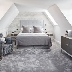 Bright and spacious day use suite with lounge seating and coffee maker at Barnett Hill Hotel.