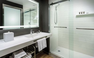 Guest bathroom with shower at AC Hotel By Marriott SFO/Oyster Point Waterfront.