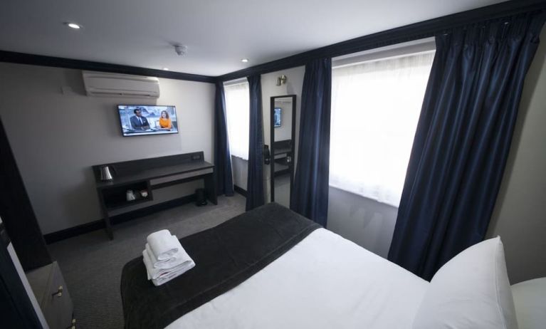Bright and spacious day use room with TV screen and work desk at The Pack And Carriage London Hotel.