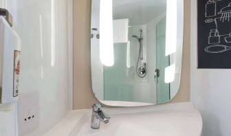 Private guest bathroom with shower at ibis Sheffield City.