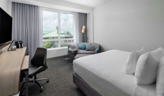 Day use room with sofa and work desk at Courtyard Delray Beach.
