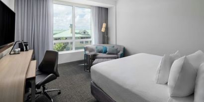 Day use room with sofa and work desk at Courtyard Delray Beach.

