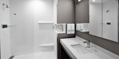 Guest bathroom with shower at Courtyard Delray Beach.
