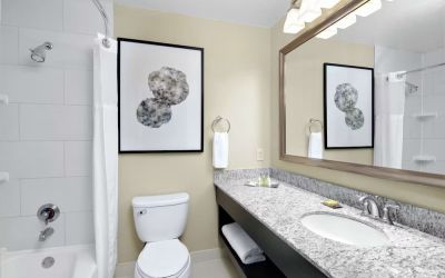 Guest bathroom with shower and tub at DoubleTree Suites By Hilton Hotel Charlotte - SouthPark.