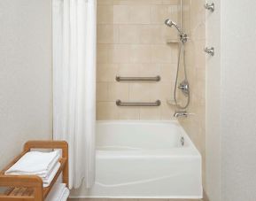 Guest bathroom with shower and tub at DoubleTree Raleigh Durham Airport At Research Triangle Park.