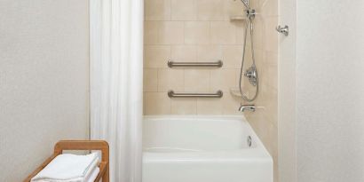 Guest bathroom with shower and tub at DoubleTree Raleigh Durham Airport At Research Triangle Park.