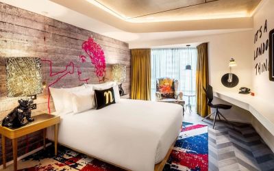 Bright and spacious day use room with floor to ceiling window and work desk at nhow London.