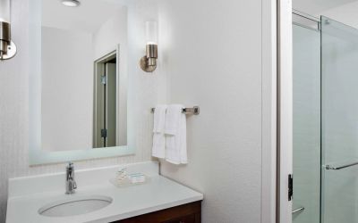 Guest bathroom with shower at Homewood Suites By Hilton Nashville.