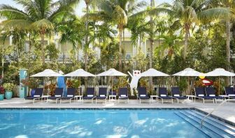 Outdoor pool with loungers at Parrot Key Hotel & Villas.