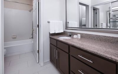Guest bathroom with shower and tub at Residence Inn By Marriott Provo.