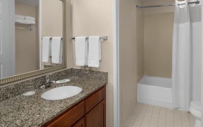 Guest bathroom with shower and tub at Residence Inn By Marriott San Diego Downtown.