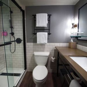 Guest bathroom with shower at Moxy Phoenix Tempe/ASU Area.