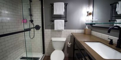 Guest bathroom with shower at Moxy Phoenix Tempe/ASU Area.