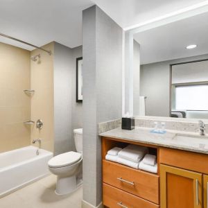 Guest bathroom with shower and tub at Hyatt HOUSE Fort Lauderdale Airport-South & Cruise Port.