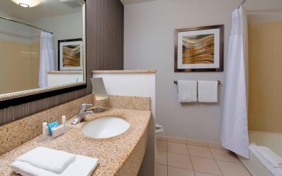 Guest bathroom with shower and tub at Courtyard By Marriott Montgomery Prattville.