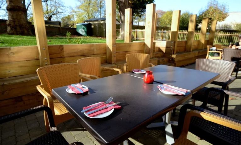 Outdoor patio with seating area at Pelican London Residence & Hotel.