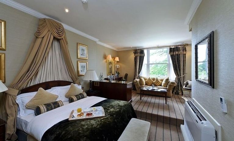 Junior suite with work desk and lounge area at The Colonnade Hotel.