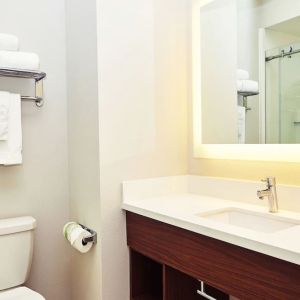 Guest bathroom with shower at Holiday Inn Express & Suites Corona.