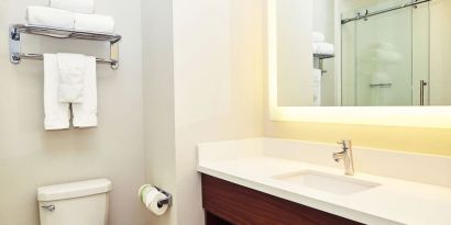 Guest bathroom with shower at Holiday Inn Express & Suites Corona.