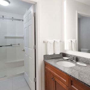 Guest bathroom with shower at Residence Inn By Marriott Bentonville Rogers.